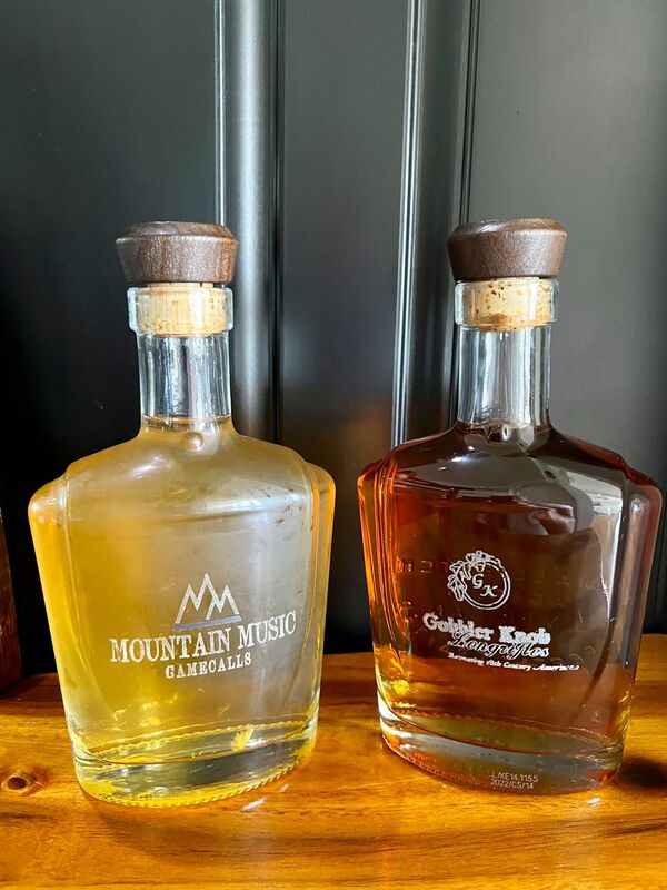 engraved glass bourbon and whiskey bottles with logo